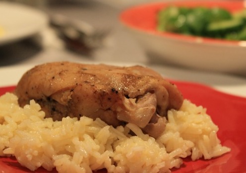 Chicken and rice on red plate