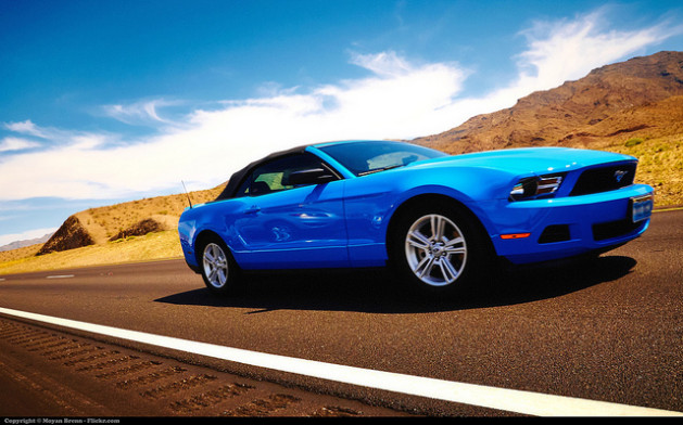 blue mustang on road