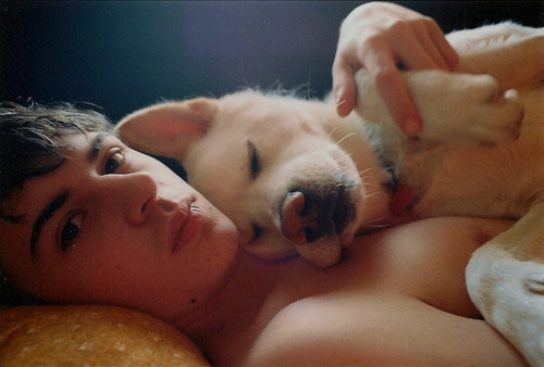 cute guy in bed with dog