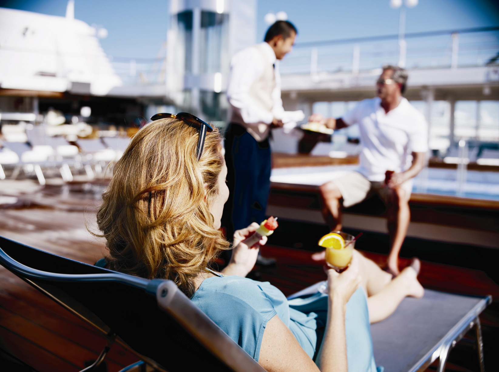 Woman and man being served on deck of cruise ship