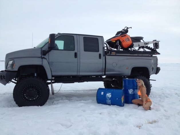 Diesel truck in snow with woman in bathing suit