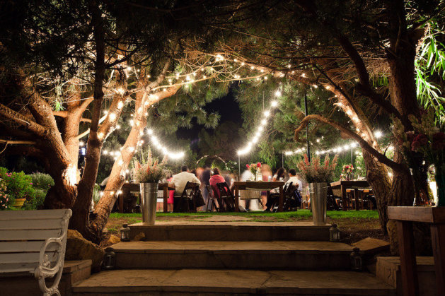Outdoor wedding with hanging lights strewn from trees