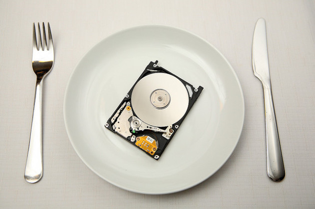 open hard drive on white plate with silverware