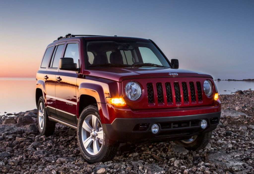 2014 red jeep patriot on rocky shore