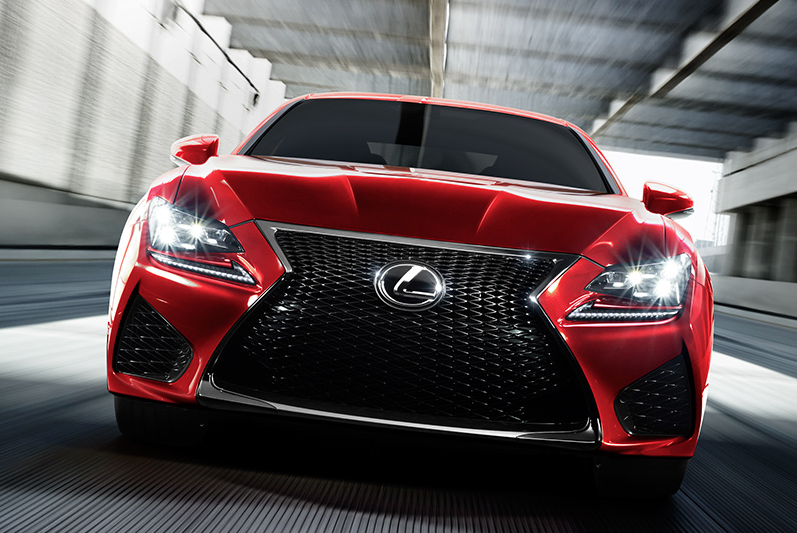 red lexus driving on a road front view