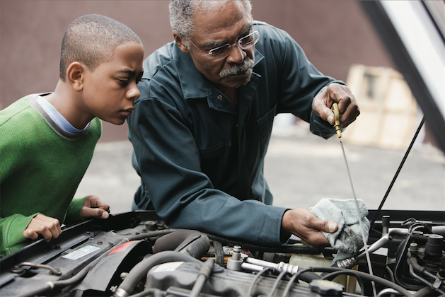 grandfather and grandson working on a car