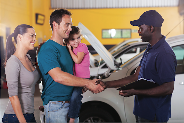 friendly mechanic handshaking with family