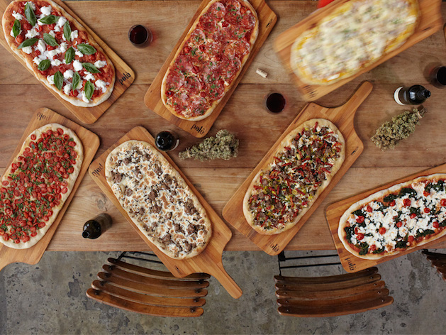 assorted pizzas on pizza peals