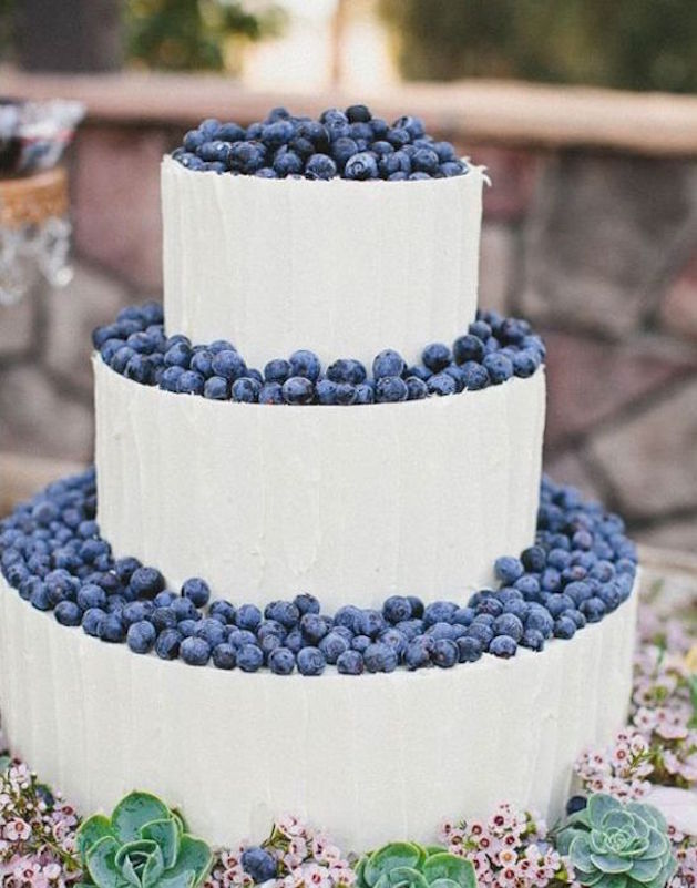 3 tiered white wedding cake with blueberries