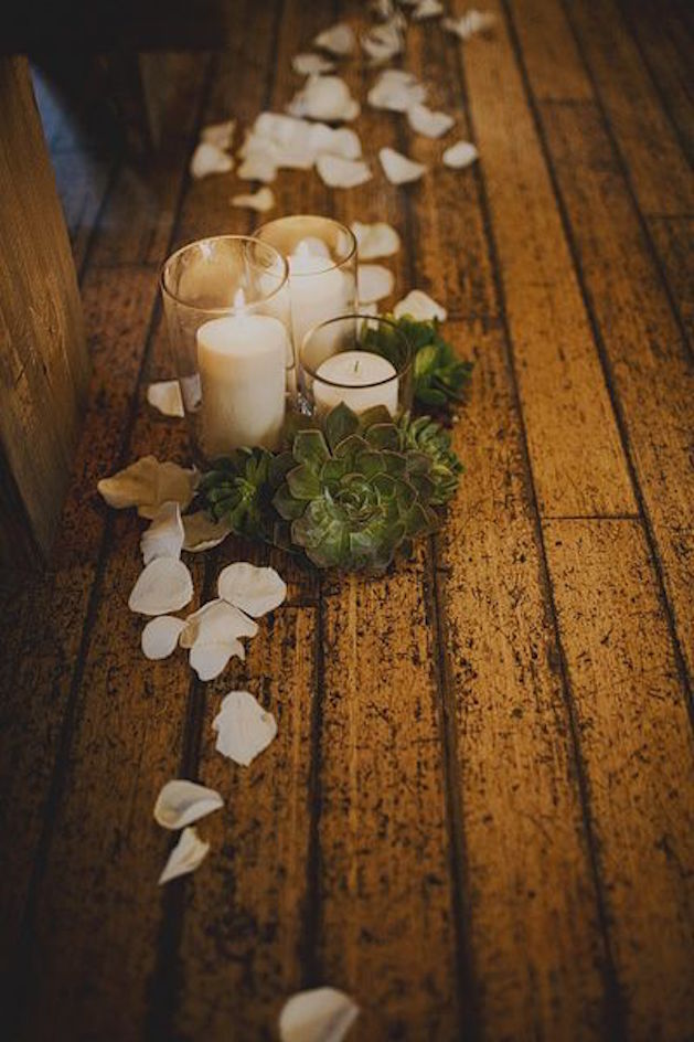 candles with succulents and white rose petals