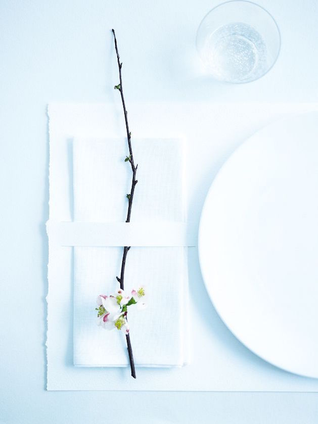 white table setting with orchid on twig