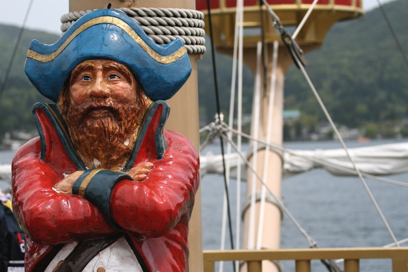 pirate captain on ship with arms crossed