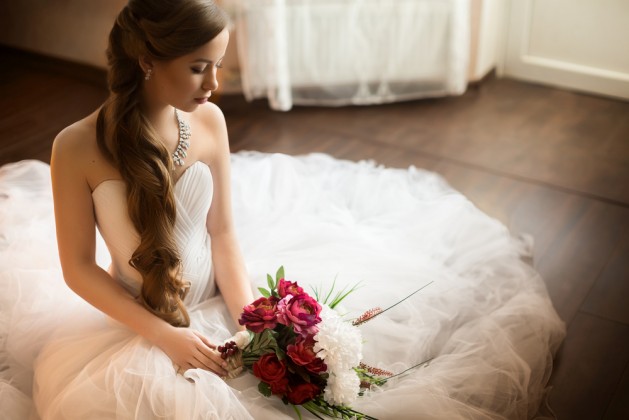 Beautiful bride with stylish make-up in white dress