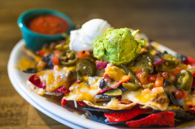 Nachos with cheese, guacamole, and sour cream