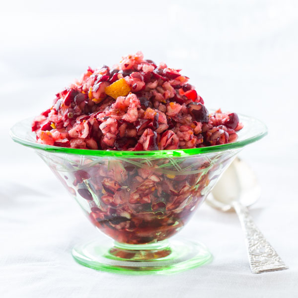 Cranberry orange relish in glass bowl with spoon