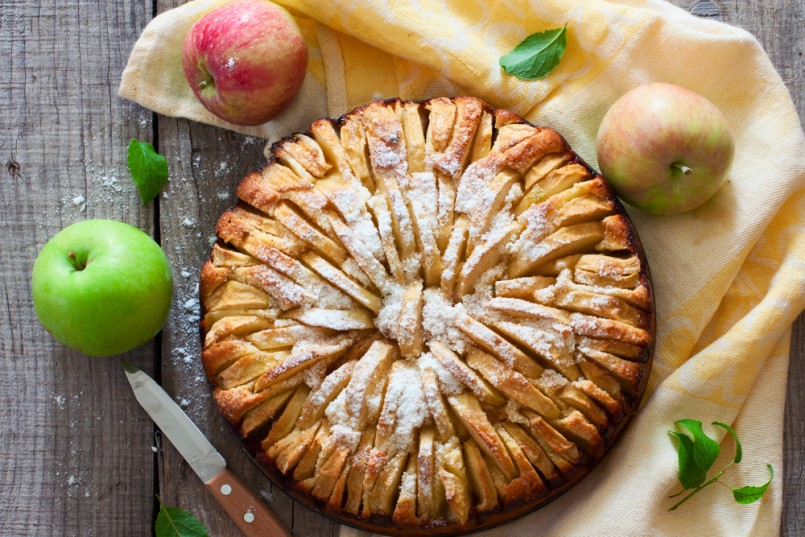 Fresh baked apple pie on the natural wood background