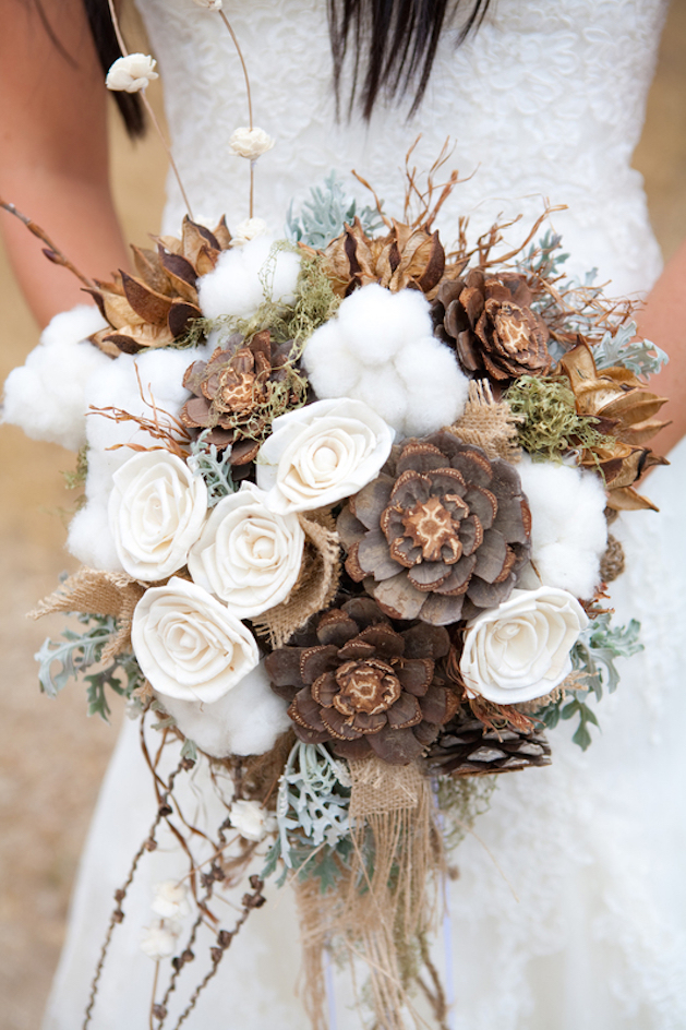 white roses cotton and pinecone flowers in bouquet