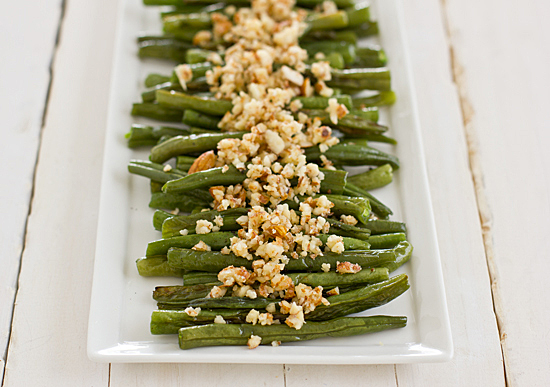 green beans with lemon almond pesto on white table