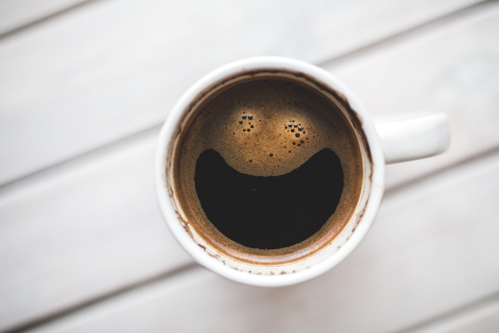 coffee in white mug with smiley face