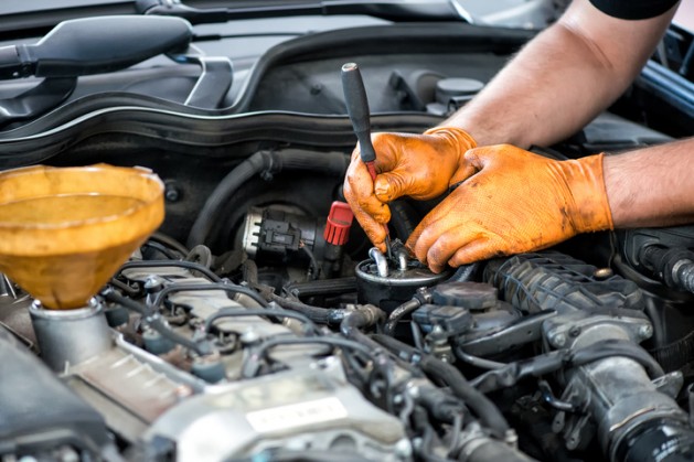 Mechanic working on a diesel filter, close up