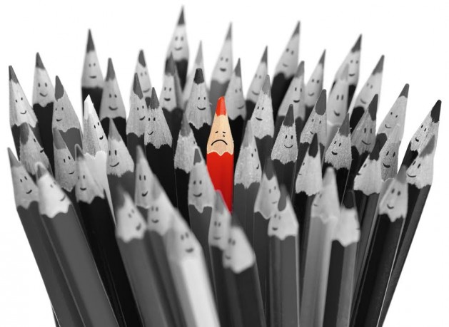 Crying red pencil among crowd of happy pencils
