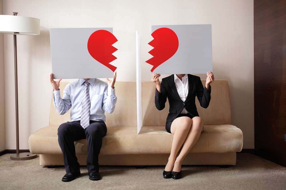 Divorce - Sad young couple holding billboard sign with break love heart, concept for divorce
