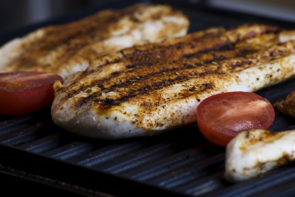 chicken breasts and cherry tomatoes on grill grilling