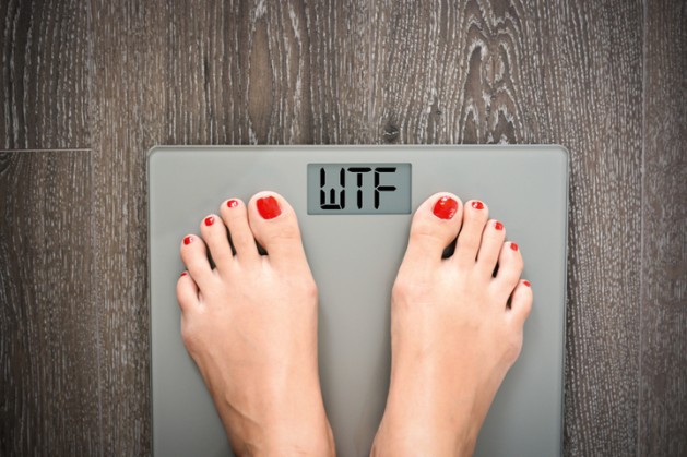 Lose Weight Concept with Person on a Scale Measuring Kilograms