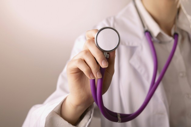 A young female doctor listening