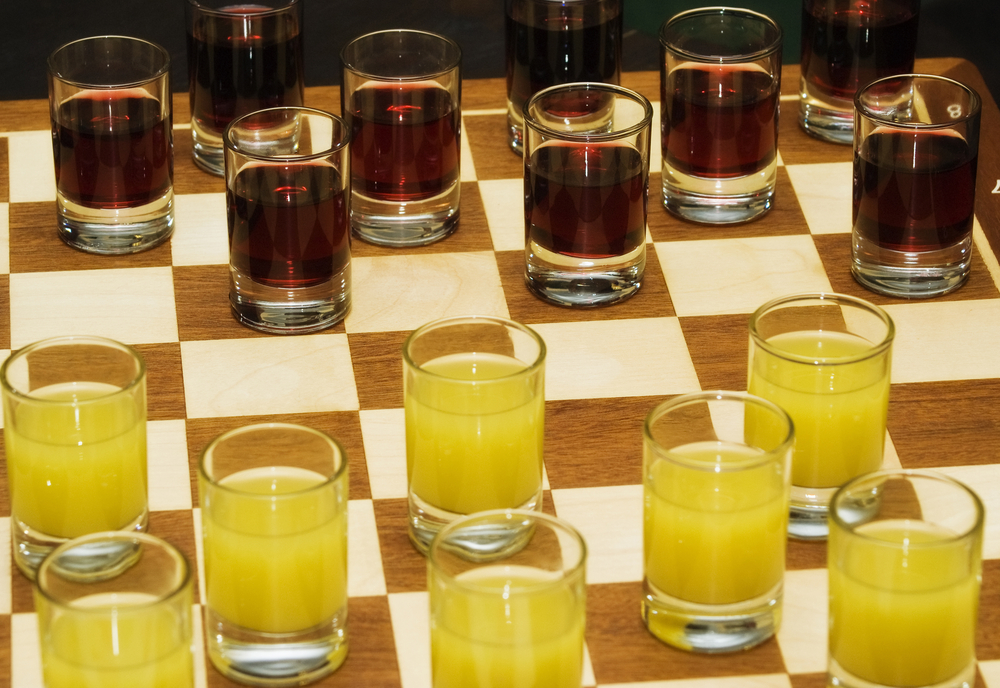 Chess set Glasses with juice on a chessboard