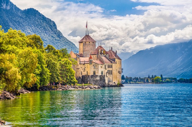 Beautiful view of famous Chateau de Chillon at Lake Geneva, one of Switzerland's major tourist attractions and most visited castles in Europe, with blue sky and clouds, Canton of Vaud, Switzerland