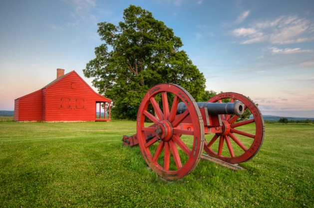 Cannon at Saratoga National Battlefield with Neilson Farm in the background