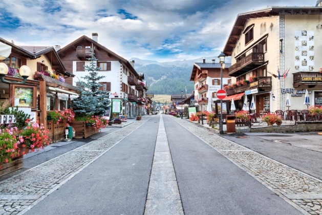 Street Lined with Quaint Buildings in Tourist Destination Village of Livigno, Italy in Valley of Italian Alps