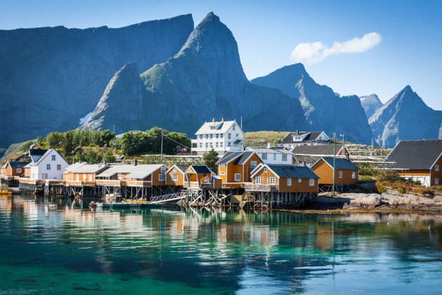 Typical Norwegian fishing village with traditional red rorbu huts, Reine, Lofoten Islands, Norway