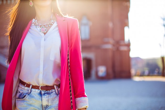 Fashion women in pink blazer with the sun in the background