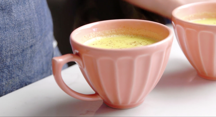 turmeric latte in pink mug