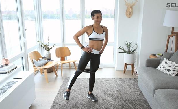 fit woman doing workout fitness in living room of home in workout clothes