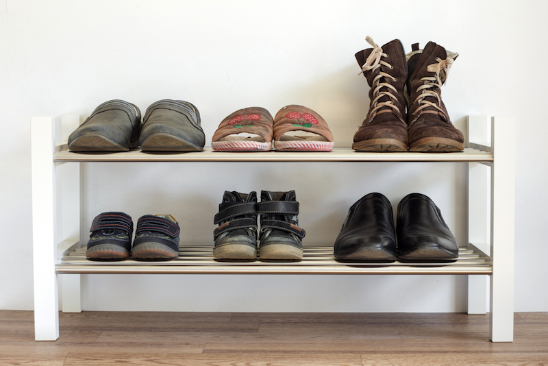 six-pairs-of-shoes-on-a-shelf-in-the-hallway-in-the-house-for-the-whole-family-dads-mamas-and-child