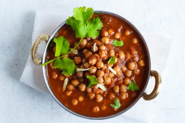 Chana Masala - Spicy Chickpea Curry , Indian Dish Chickpeas soaking in a bed of Onion Tomato gravy, garnished with Coriander leaves and Ginger Juliennes