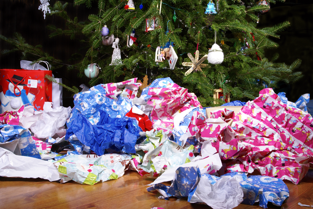 a-mess-of-wrinkled-wrapping-paper-scattered-under-the-christmas-tree