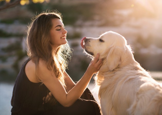 beauty-woman-with-her-dog-playing-outdoors