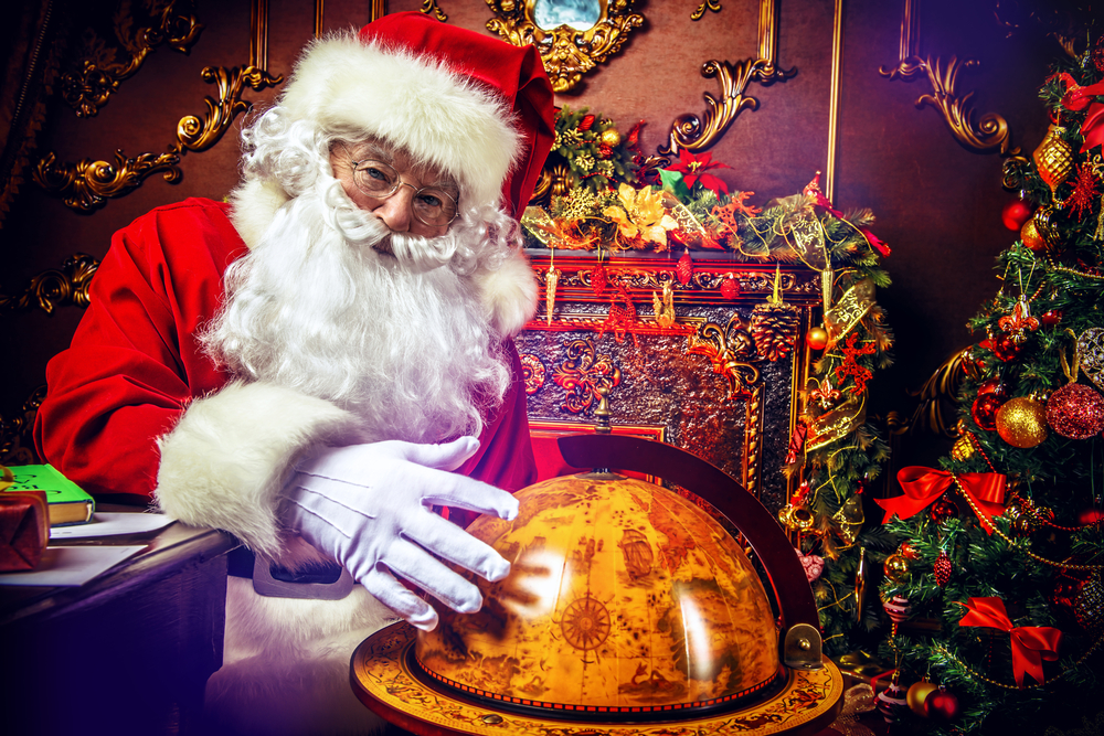 Santa Claus at home reading the post and plans to travel around the planet. Christmas time. Time for miracles.