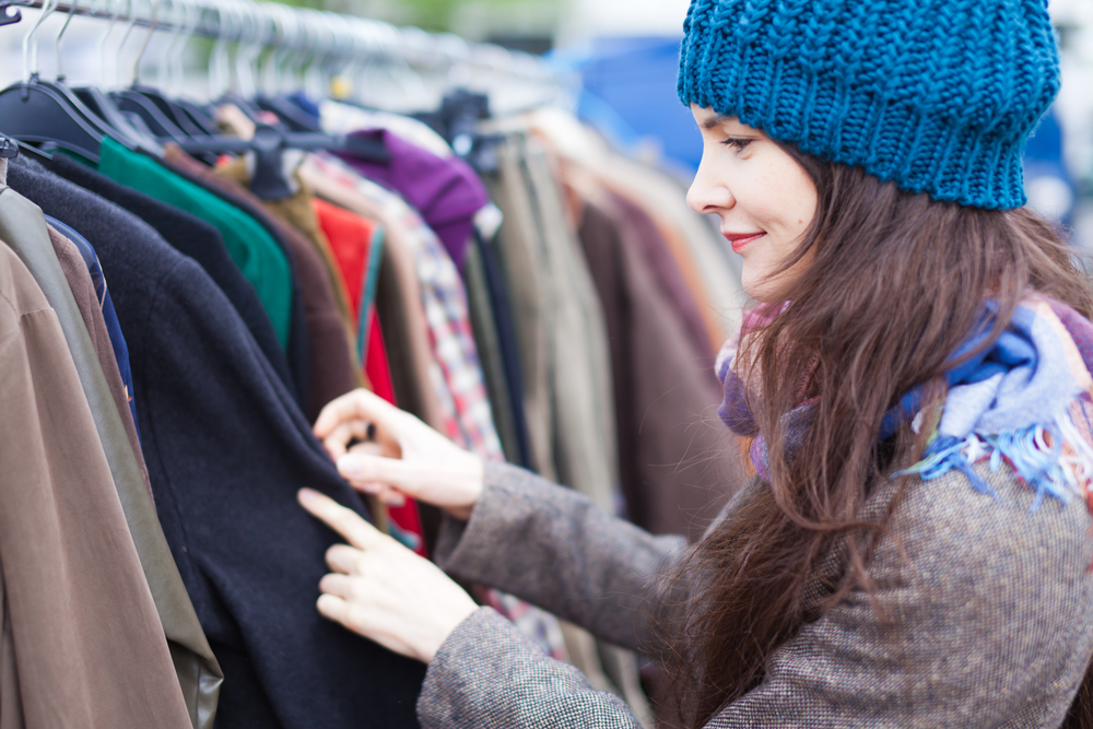 woman-choosing-clothes-at-flea-market
