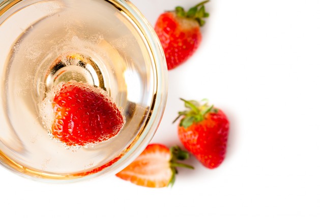 cold champagne with strawberries on a white background, isolated, close-up