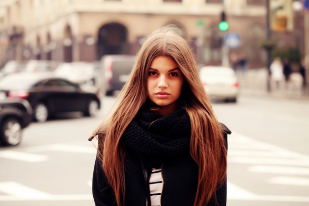 Portrait of beautiful girl outdoors. Young hipster woman in the city traffic learning to say no, self empowerment