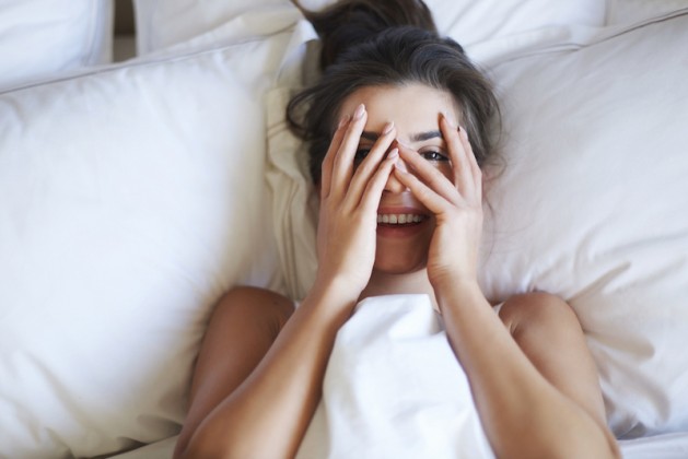 shy sleepy woman in bed morning person 