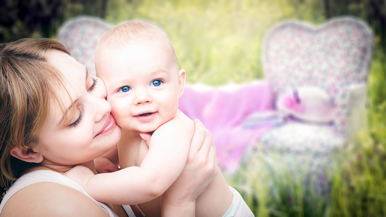 Mother holding baby, outside