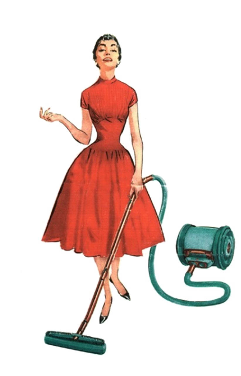 Woman in dress vacuuming