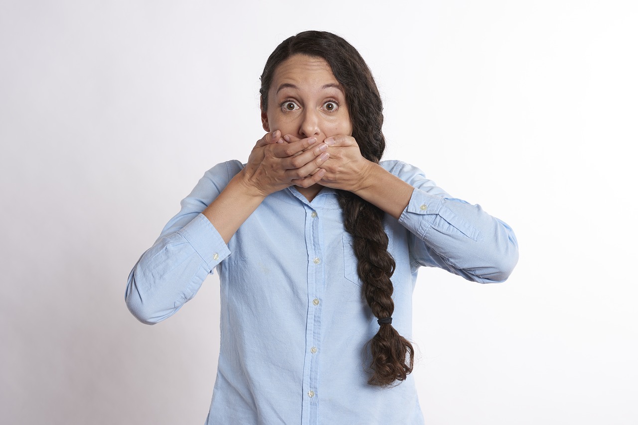 Woman covering her mouth