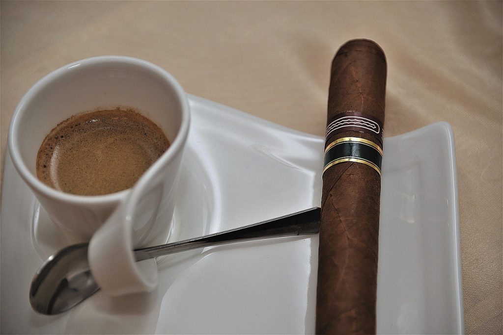 best cigars under $20 Cigar on white plate next to cuban coffee